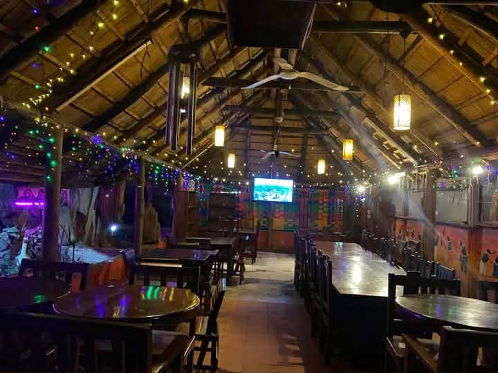 The cosy thatched-roof dining room at The Hut Restaurant in Kitwe