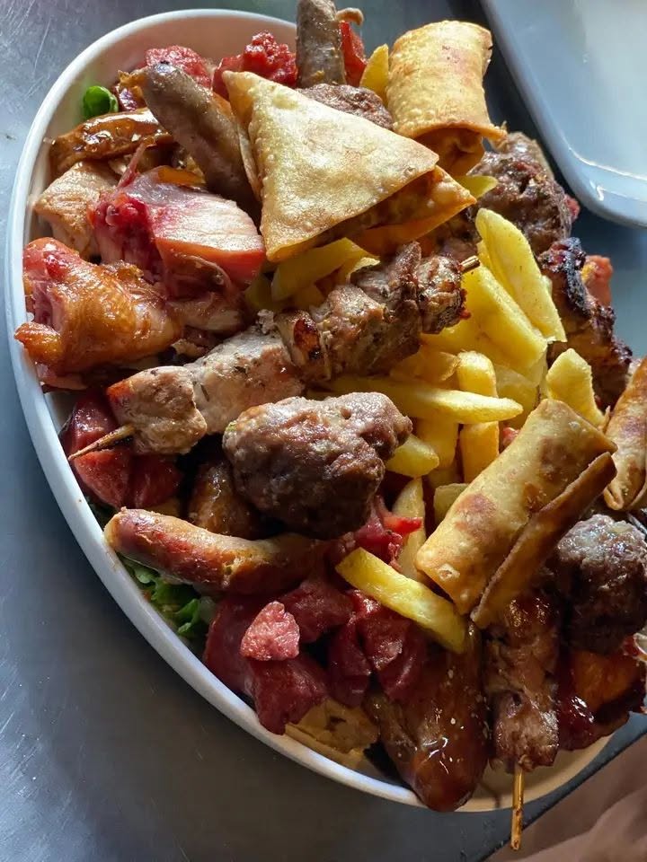Loaded mixed grill platter with meats and sides