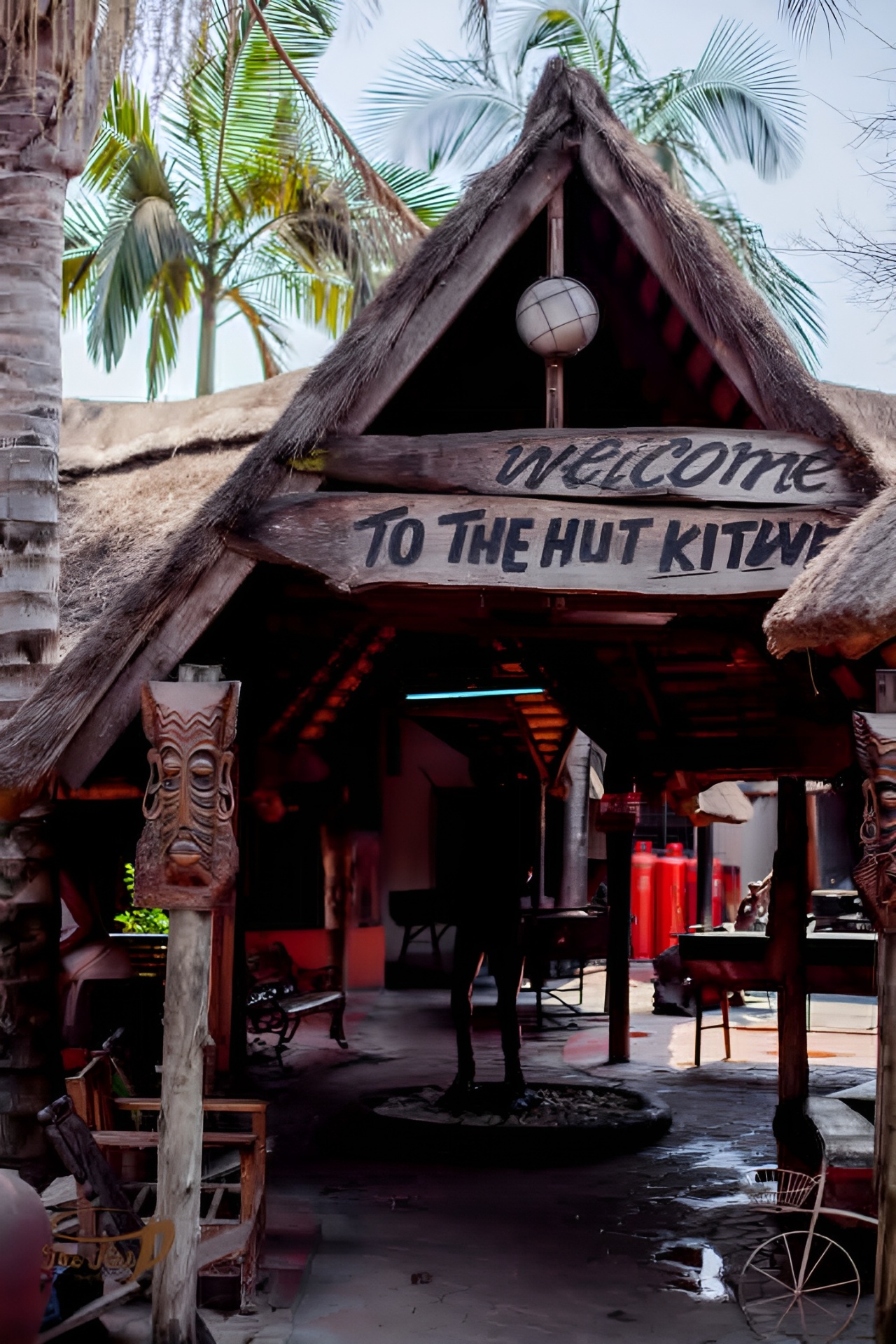 Welcome to The Hut Kitwe — thatched entrance with carved wooden signage