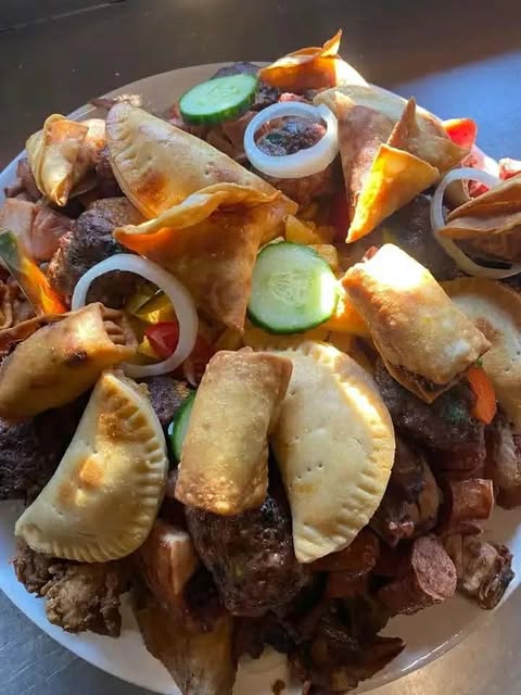 Loaded mixed grill sharing platter with meats, samoosas and salad