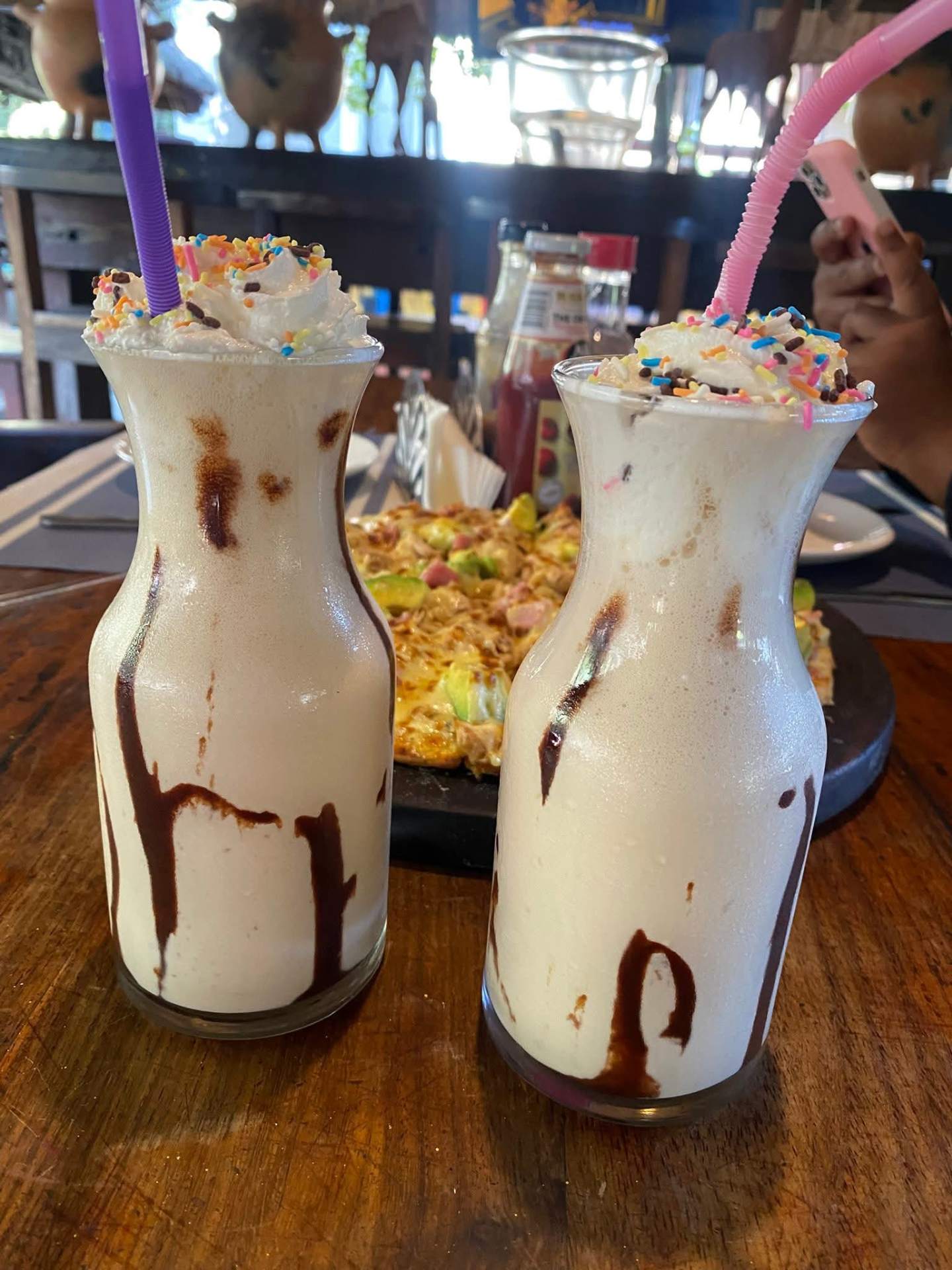 Thick milkshakes with chocolate drizzle and rainbow sprinkles