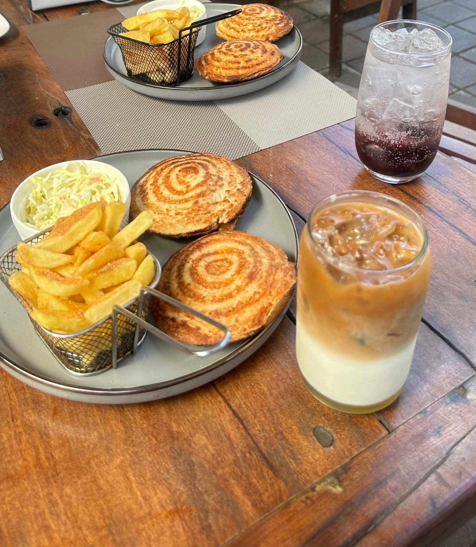 Toasted sandwiches with chips, coleslaw and an iced coffee latte