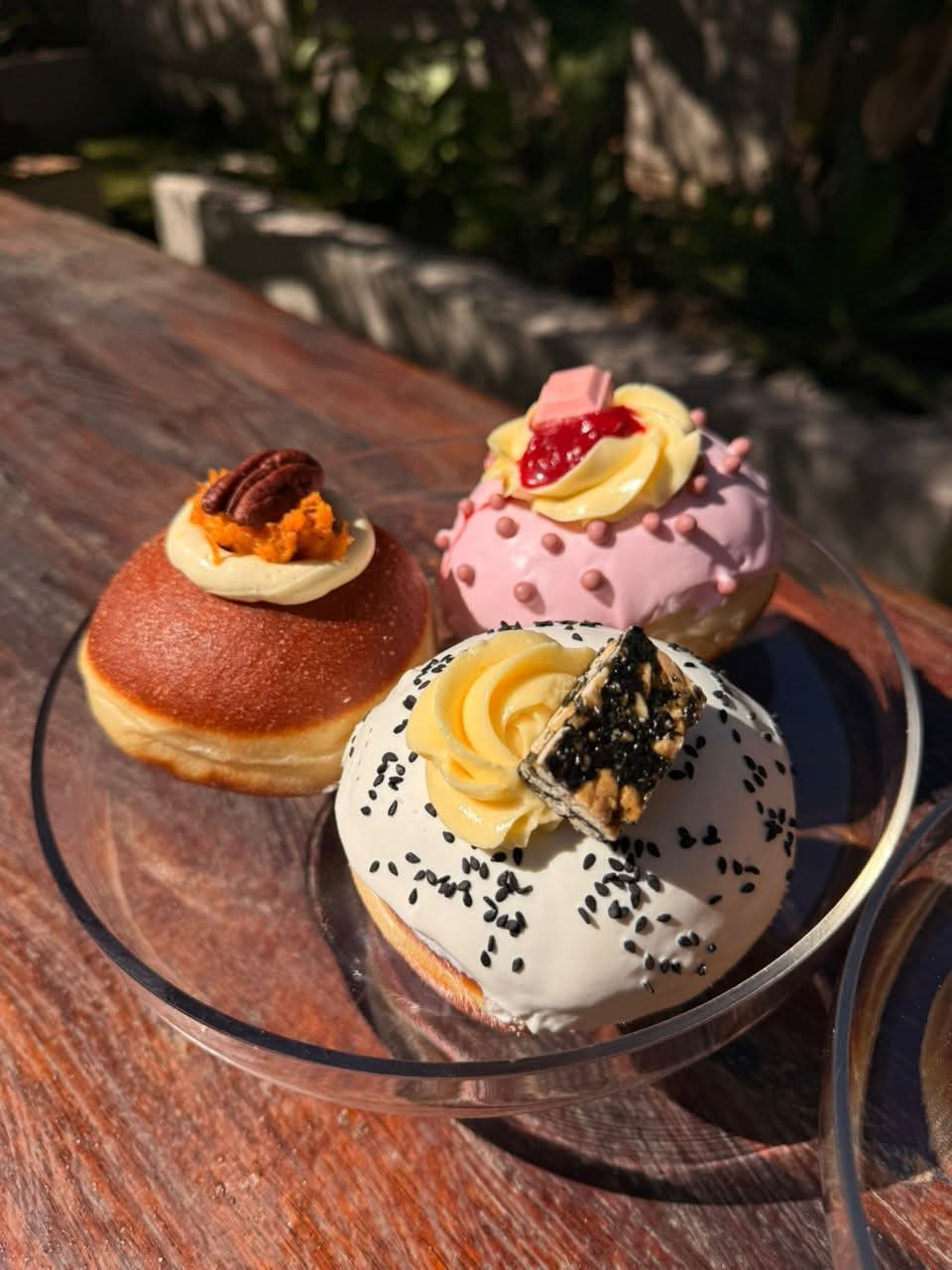 Gourmet filled donuts topped with cream and pecans
